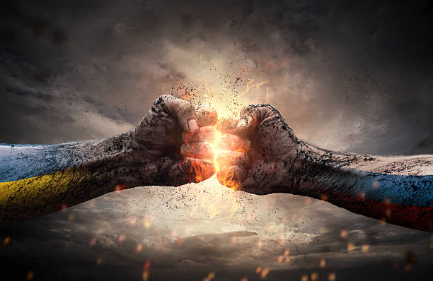 Close up of two fists hitting each other over dramatic sky