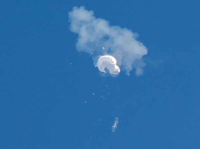 The Chinese spy balloon drifts to the ocean after being shot down.