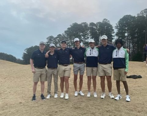 Mens team posing for a picture after their match