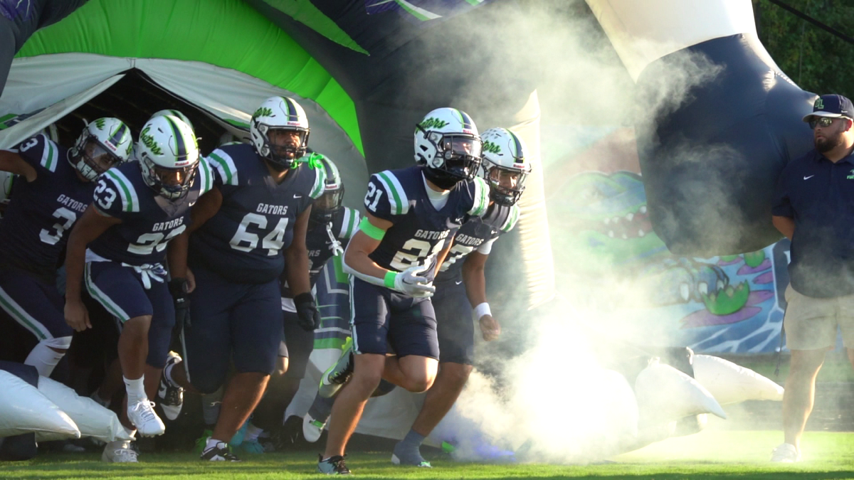 The Green Level football team entering the field.
