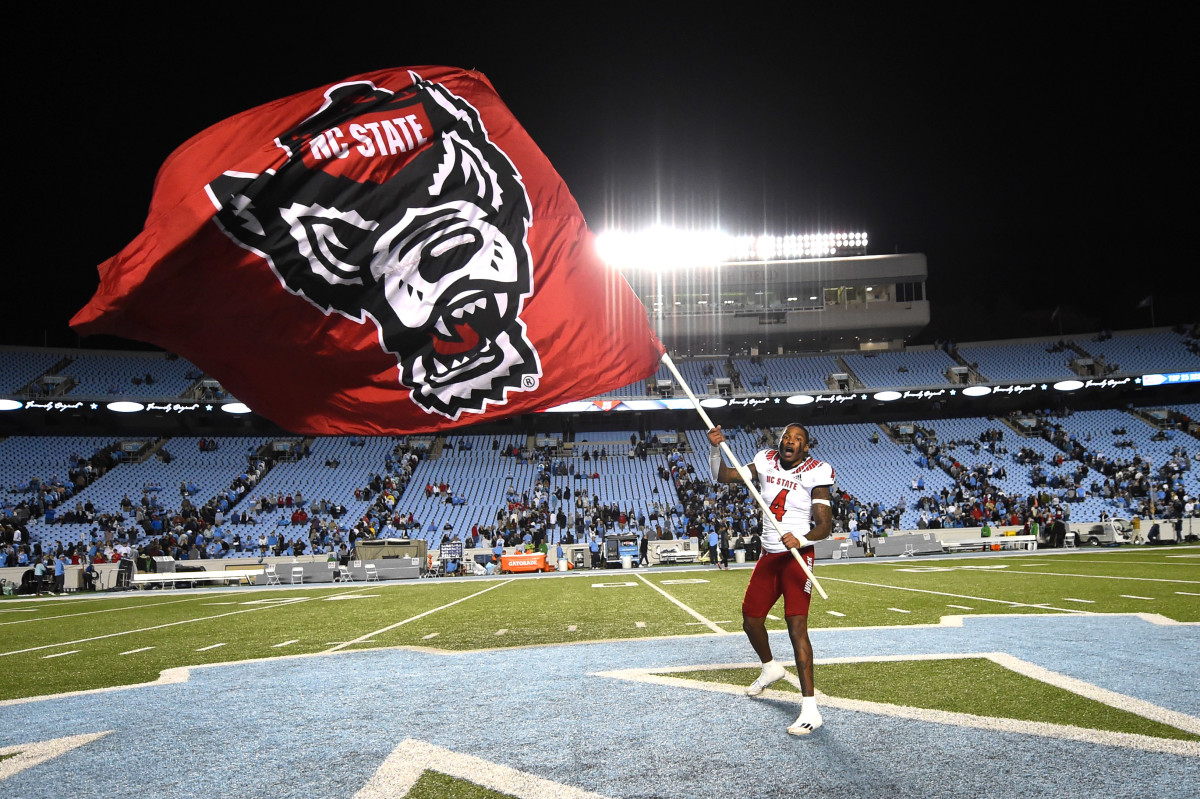 Dacari Collins waving the NC State flag with pride following their victory over UNC