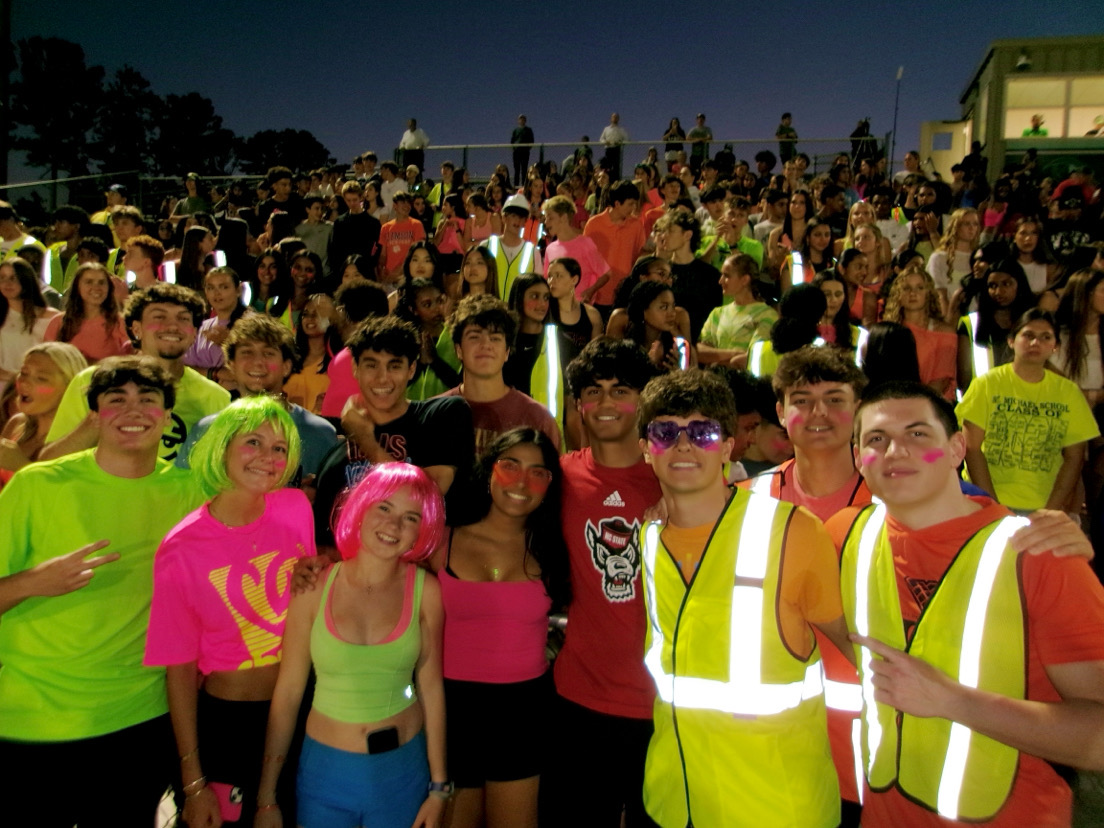 Students pack the stand at the Neon Out Football game. 