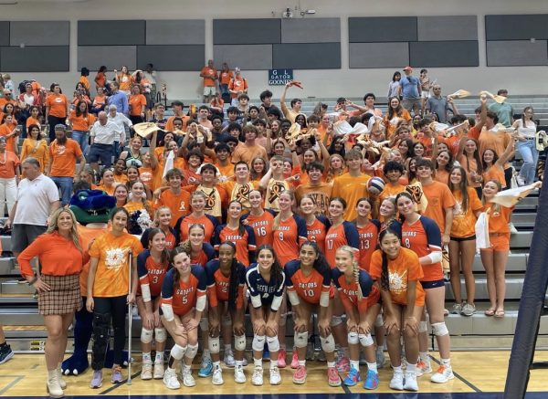 Green Level fans pack the gym sporting their orange to support the team. 