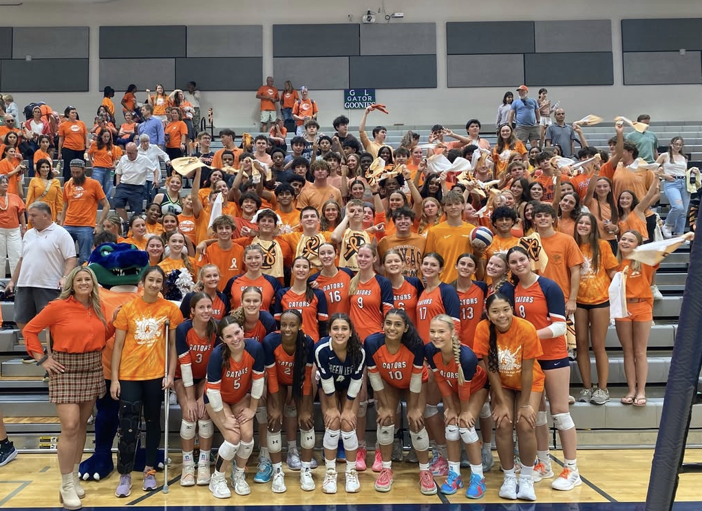 Green Level fans pack the gym sporting their orange to support the team. 