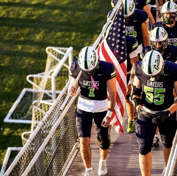 The Green Level Football team walk out before the game. 